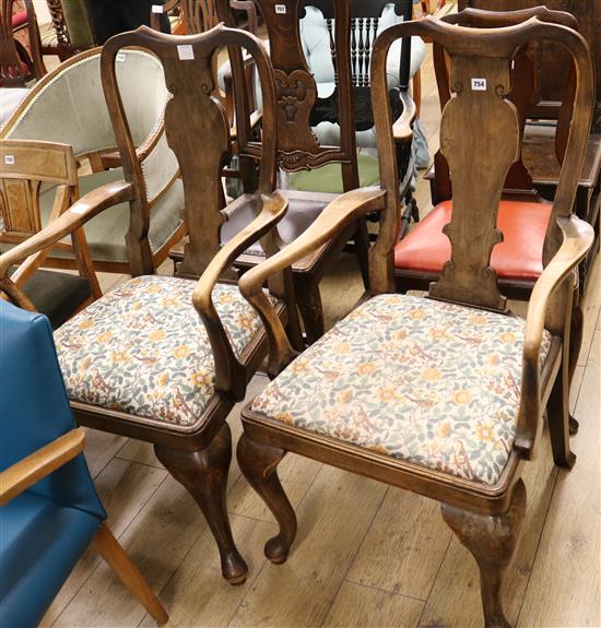 A pair of George I style beech open elbow chairs
